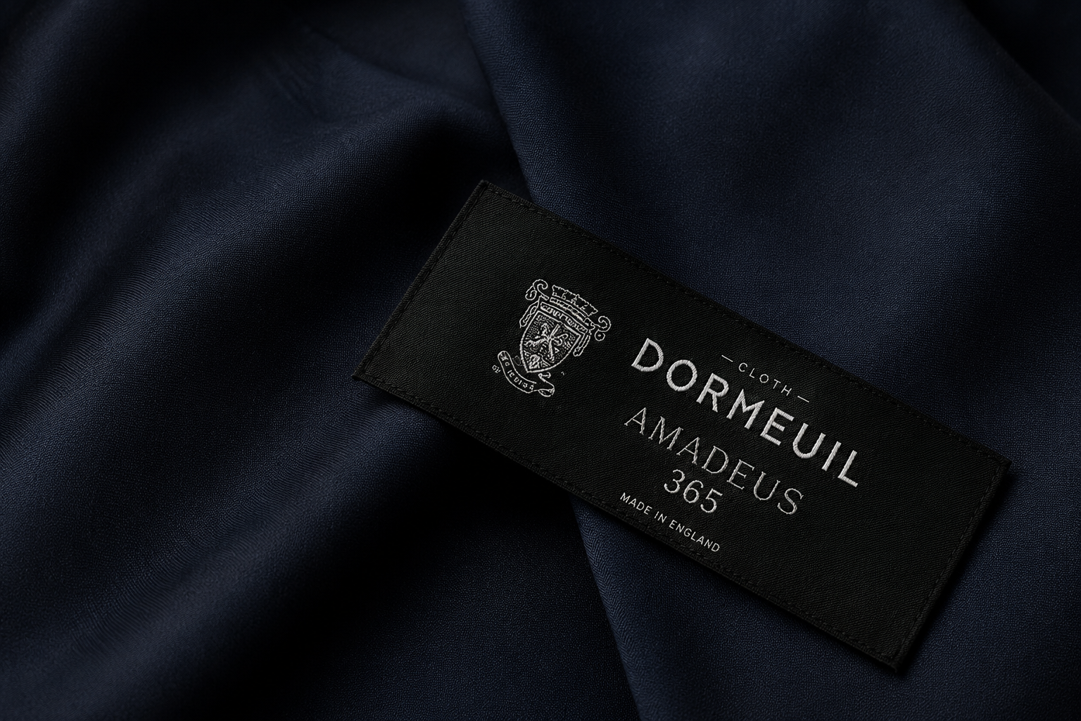Dormeuil amadeus luxury fabric label on navy suiting fabric for custom suits in charlotte